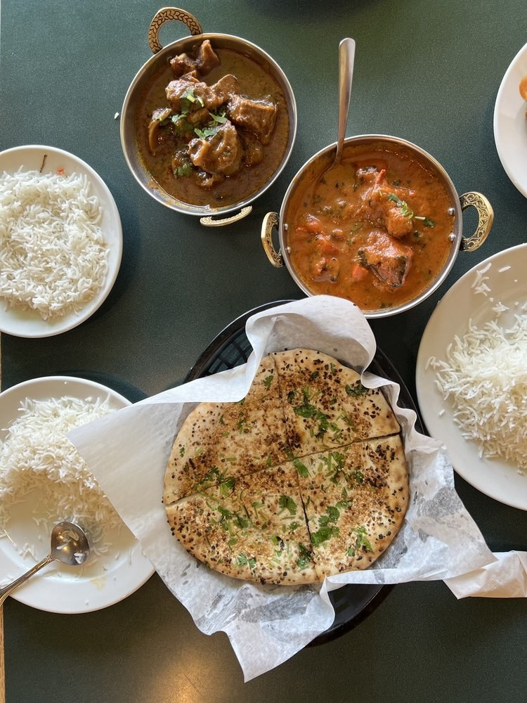 Curries served with fresh naan and rice